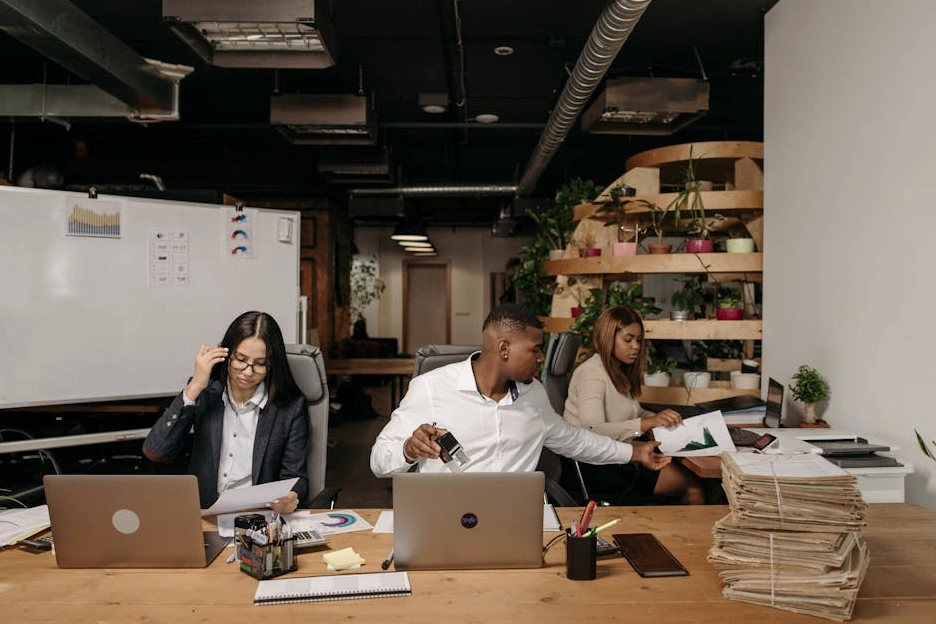 A diverse team of financial advisors in a modern office, engaged in a discussion.